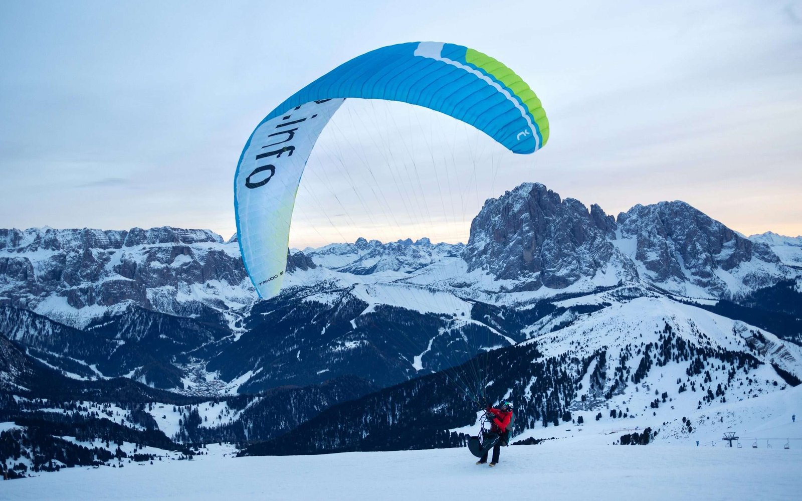pexels-photo-18831974-18831974 Paraglider launching at snowy landscape in the Dolomites at sunset.